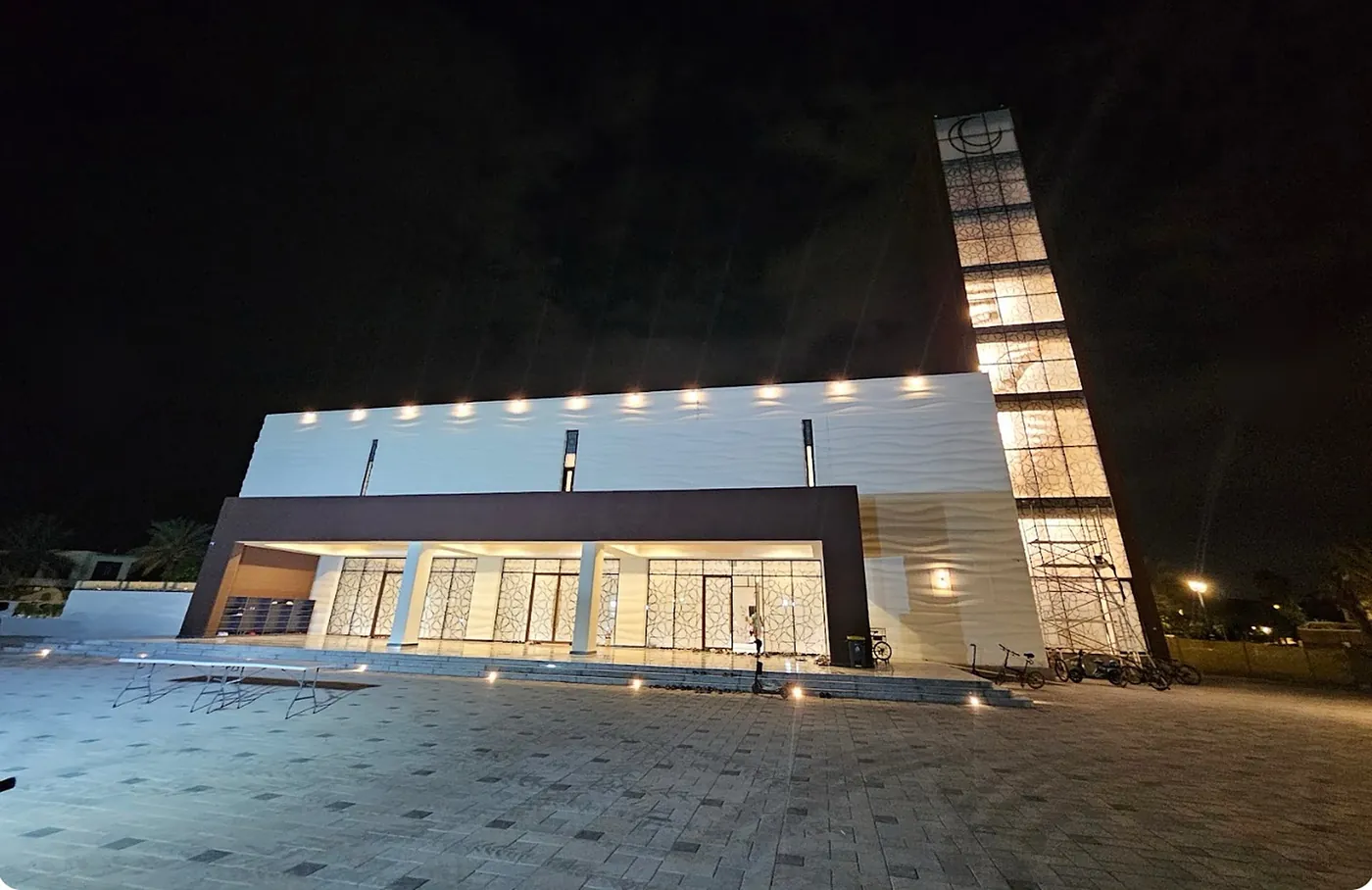 The masjid at night with its illuminated minaret